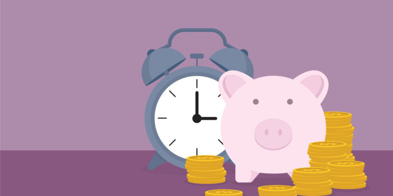 Piggy bank, clock, and a stack of coin